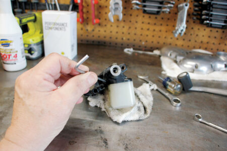 A hand holding a master cylinder